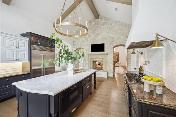 Fireplace, Interior, Kitchen, Pendant Lights, Stainless Steel Appliances, Stone Walls, Wood Texture Flooring