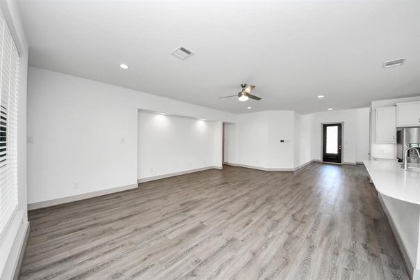 Empty room, Interior, Kitchen, Recessed Lighting, Stainless Steel Appliances, Wood Texture Flooring