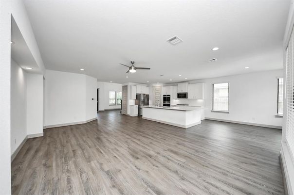 Empty room, Interior, Kitchen, Recessed Lighting, Stainless Steel Appliances, Wood Texture Flooring