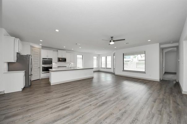 Empty room, Interior, Kitchen, Recessed Lighting, Stainless Steel Appliances, Wood Texture Flooring