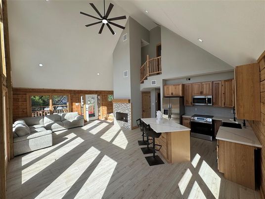 Fireplace, Interior, Kitchen, Living room, Pendant Lights, Recessed Lighting, Stainless Steel Appliances, Wood Texture Flooring