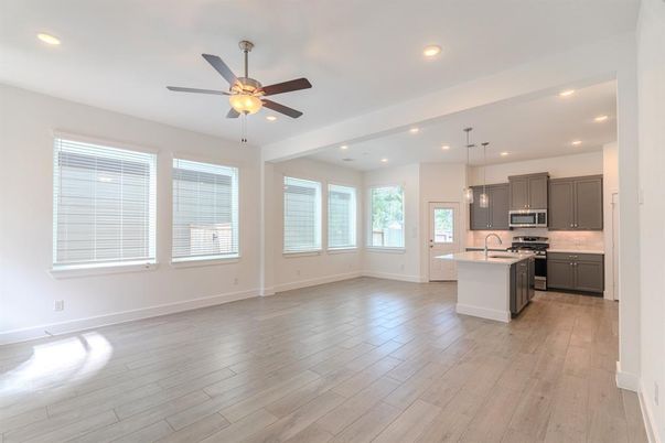 Empty room, Interior, Kitchen, Pendant Lights, Recessed Lighting, Stainless Steel Appliances, Wood Texture Flooring