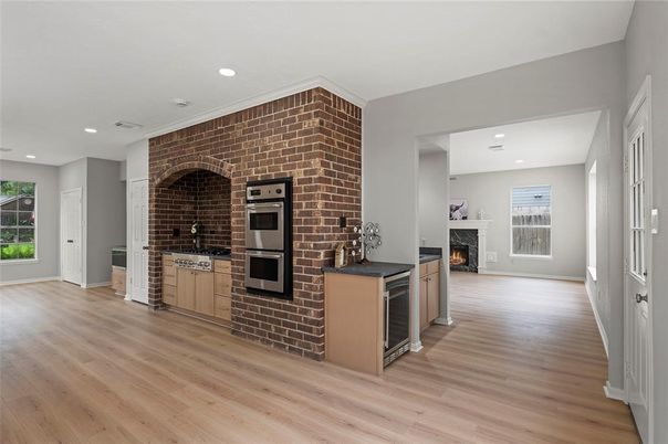 Fireplace, Interior, Kitchen, Recessed Lighting, Stainless Steel Appliances, Stone Walls, Wood Texture Flooring