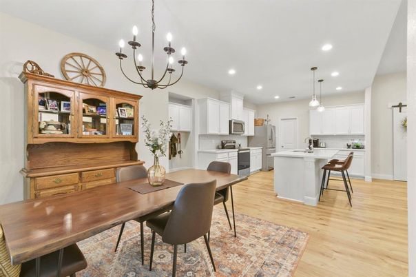 Chandelier, Dining room, Interior, Kitchen, Pendant Lights, Recessed Lighting, Stainless Steel Appliances, Wood Texture Flooring