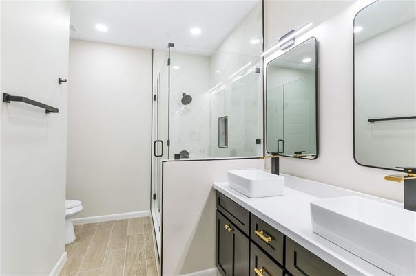 Bathroom, Dual Sink Vanities, Glass Shower, Interior, Recessed Lighting, Wood Texture Flooring