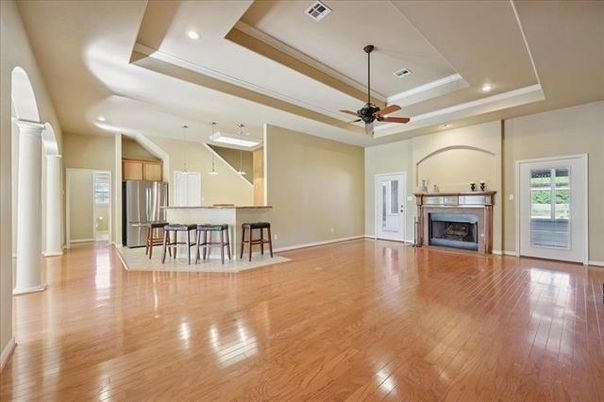 Empty room, Fireplace, Interior, Kitchen, Recessed Lighting, Stainless Steel Appliances, Wood Texture Flooring