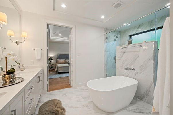 Bathroom, Bedroom, Dual Sink Vanities, Free Standing Baths, Glass Shower, Interior, Marble, Marble Walls, Recessed Lighting, Wood Texture Flooring