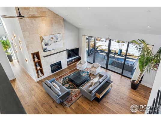 Fireplace, Interior, Living room, Recessed Lighting, Stone Walls, Water, Wood Texture Flooring