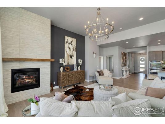 Chandelier, Fireplace, Interior, Kitchen, Living room, Recessed Lighting, Stainless Steel Appliances, Wood Texture Flooring