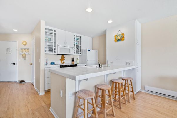 Interior, Kitchen, Recessed Lighting, Tile Countertops, Wood Texture Flooring