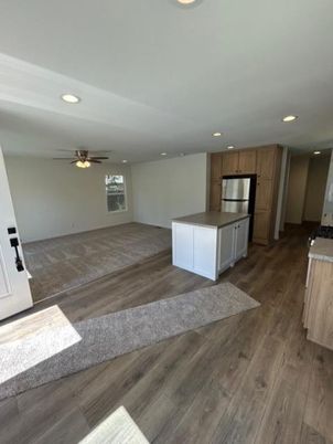 Empty room, Interior, Kitchen, Recessed Lighting, Stainless Steel Appliances, Wood Texture Flooring