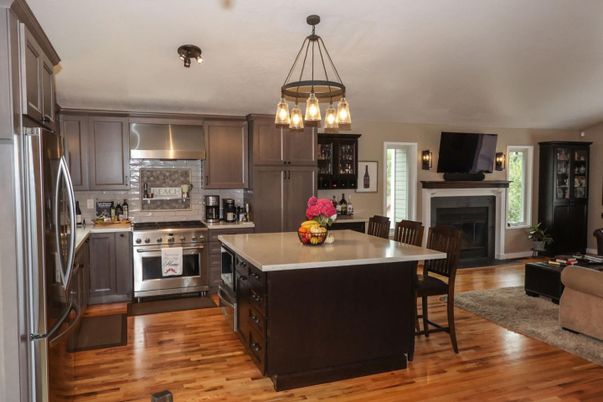 Dining room, Fireplace, Interior, Kitchen, Pendant Lights, Stainless Steel Appliances, Wood Texture Flooring