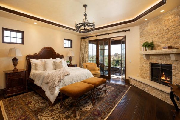 Bedroom, Chandelier, Fireplace, Interior, Recessed Lighting, Stone Walls, Wood Texture Flooring