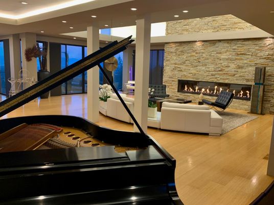 Fireplace, Interior, Living room, Piano, Recessed Lighting, Stone Walls, Wood Texture Flooring