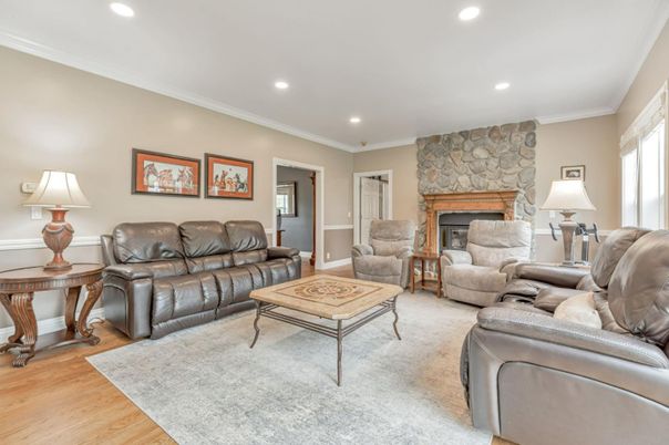 Fireplace, Interior, Living room, Recessed Lighting, Stone Walls, Wood Texture Flooring