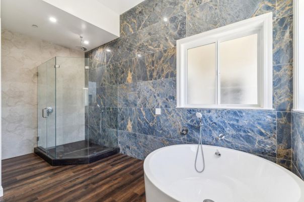 Bathroom, Free Standing Baths, Glass Shower, Interior, Marble Walls, Recessed Lighting, Wood Texture Flooring