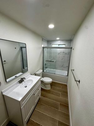 Bathroom, Dual Sink Vanities, Glass Shower, Interior, Marble Walls, Recessed Lighting, Wood Texture Flooring