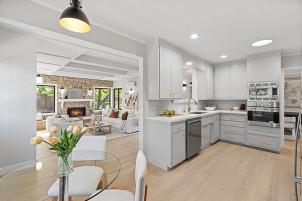 Fireplace, Interior, Kitchen, Living room, Pendant Lights, Recessed Lighting, Stainless Steel Appliances, Stone Walls, Wood Texture Flooring