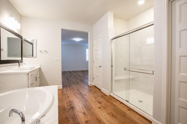 Bathroom, Dual Sink Vanities, Glass Shower, Interior, Recessed Lighting, Wood Texture Flooring