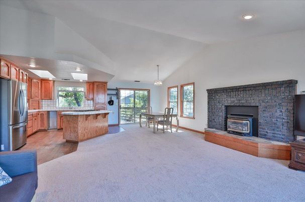 Chandelier, Dining room, Fireplace, Interior, Kitchen, Pendant Lights, Recessed Lighting, Stainless Steel Appliances, Stone Walls