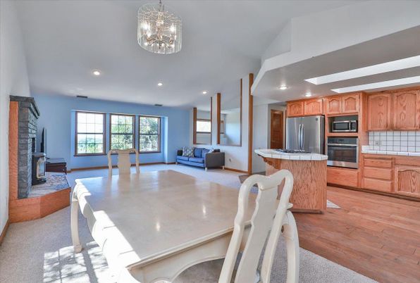 Dining room, Fireplace, Interior, Kitchen, Recessed Lighting, Stainless Steel Appliances, Wood Texture Flooring