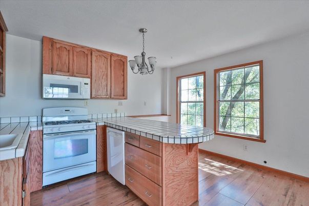 Chandelier, Interior, Kitchen, Tile Countertops, Wood Texture Flooring