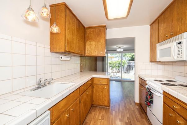 Interior, Kitchen, Pendant Lights, Tile Countertops, Wood Texture Flooring