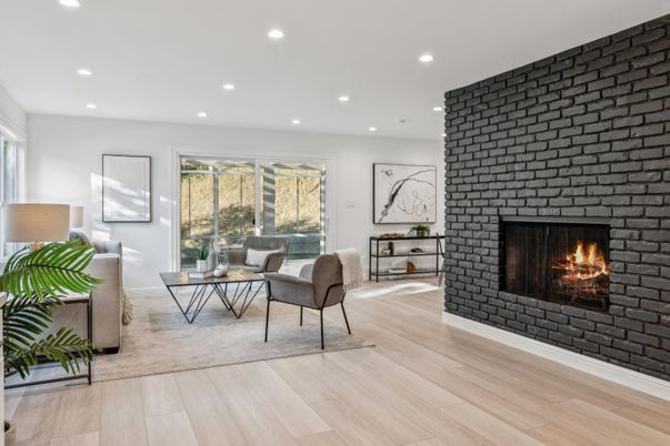Fireplace, Interior, Living room, Recessed Lighting, Stone Walls, Wood Texture Flooring