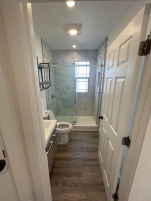Bathroom, Glass Shower, Interior, Marble Walls, Recessed Lighting, Wood Texture Flooring