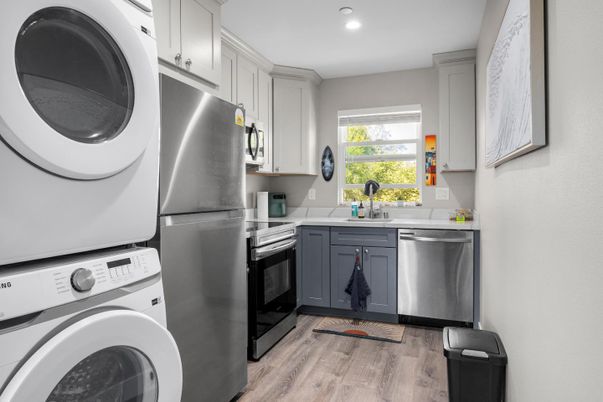 Interior, Kitchen, Recessed Lighting, Stainless Steel Appliances, Washer, Wood Texture Flooring