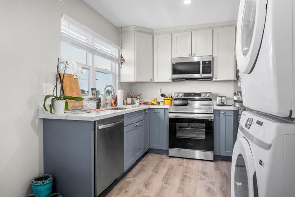 Interior, Kitchen, Recessed Lighting, Stainless Steel Appliances, Washer, Wood Texture Flooring