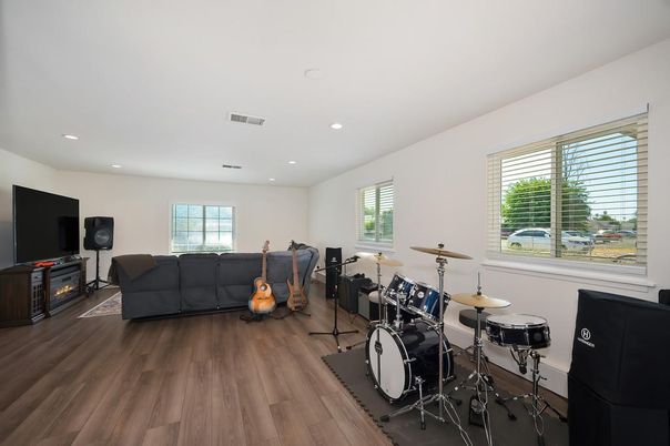 Fireplace, Fitness Equipment, Interior, Living room, Recessed Lighting, Wood Texture Flooring