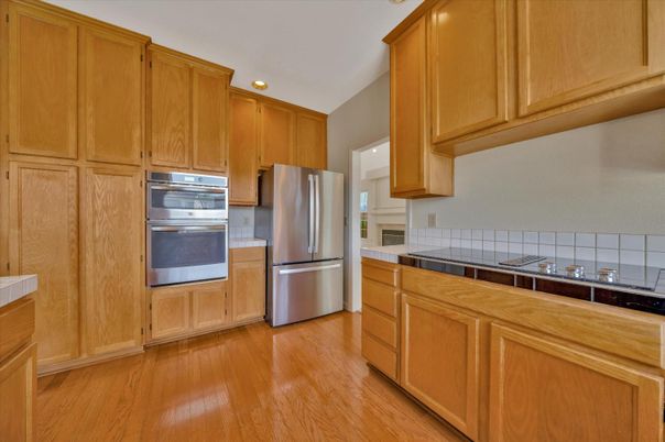 Interior, Kitchen, Recessed Lighting, Stainless Steel Appliances, Tile Countertops, Wood Texture Flooring
