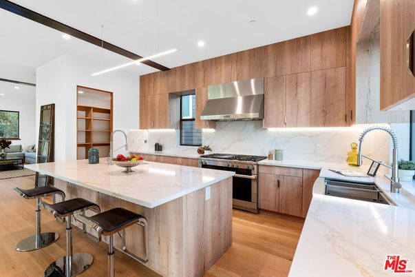 Interior, Kitchen, Marble Walls, Recessed Lighting, Stainless Steel Appliances, Wood Texture Flooring