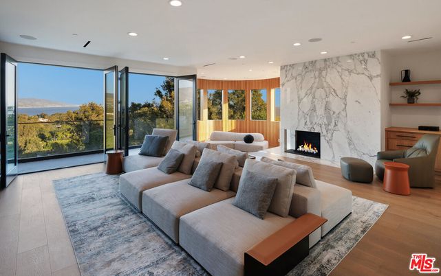 Fireplace, Interior, Living room, Marble Walls, Recessed Lighting, Wood Texture Flooring