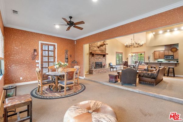 Chandelier, Dining room, Fireplace, Interior, Kitchen, Living room, Recessed Lighting, Stainless Steel Appliances, Stone Walls
