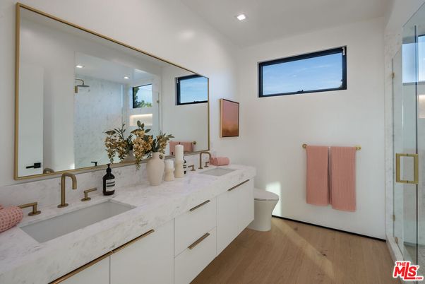 Bathroom, Dual Sink Vanities, Glass Shower, Interior, Marble Walls, Recessed Lighting, Wood Texture Flooring