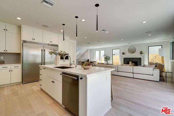 Fireplace, Interior, Kitchen, Living room, Pendant Lights, Recessed Lighting, Stainless Steel Appliances, Wood Texture Flooring