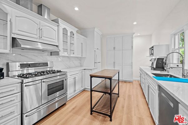 Interior, Kitchen, Marble Walls, Recessed Lighting, Stainless Steel Appliances, Wood Texture Flooring