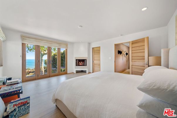 Bedroom, Fireplace, Interior, Recessed Lighting, Water, Wood Texture Flooring