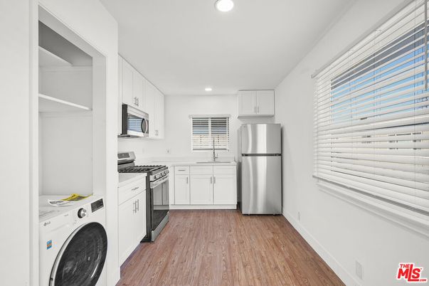 Interior, Kitchen, Recessed Lighting, Washer, Wood Texture Flooring