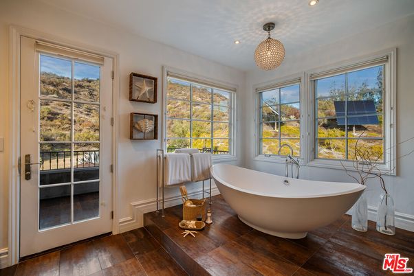 Bathroom, Chandelier, Free Standing Baths, Interior, Pendant Lights, Recessed Lighting, Wood Texture Flooring