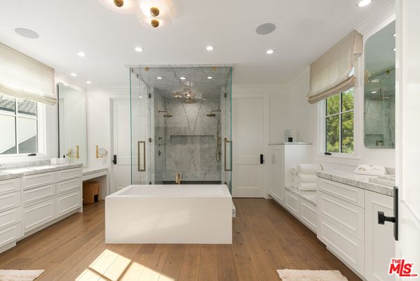 Bathroom, Dual Sink Vanities, Glass Shower, Interior, Marble Walls, Recessed Lighting, Wood Texture Flooring