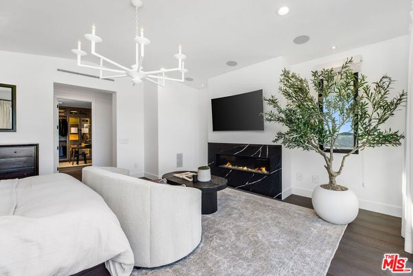 Bedroom, Chandelier, Fireplace, Interior, Living room, Recessed Lighting, Wine Storage, Wood Texture Flooring