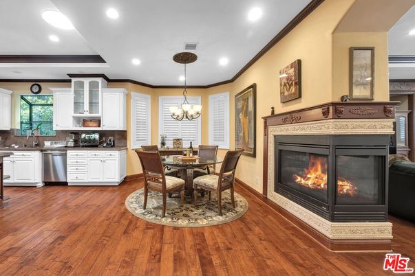 Chandelier, Dining room, Fireplace, Interior, Kitchen, Recessed Lighting, Stainless Steel Appliances, Wood Texture Flooring