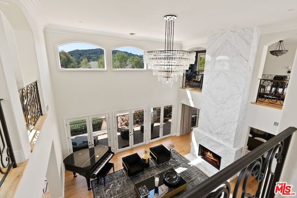 Chandelier, Fireplace, Interior, Living room, Marble Walls, Recessed Lighting, Wood Texture Flooring