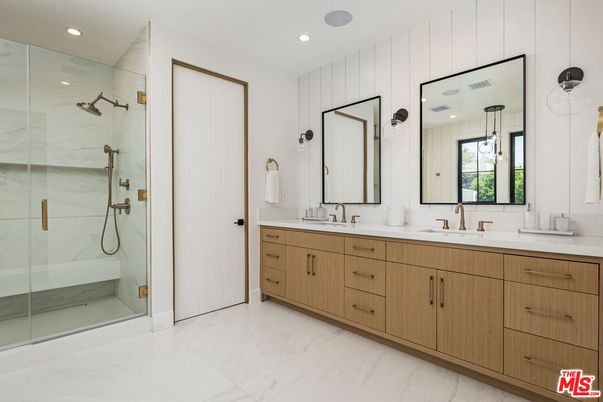 Bathroom, Dual Sink Vanities, Glass Shower, Interior, Marble, Marble Walls, Pendant Lights, Recessed Lighting