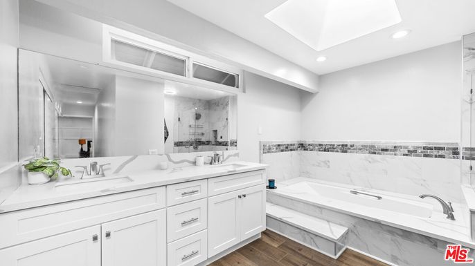 Bathroom, Dual Sink Vanities, Interior, Marble Walls, Recessed Lighting, Wood Texture Flooring