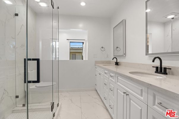 Bathroom, Dual Sink Vanities, Glass Shower, Interior, Marble, Marble Walls, Recessed Lighting