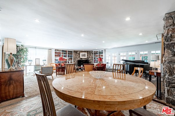 Dining room, Fireplace, Interior, Living room, Piano, Recessed Lighting, Stone Walls, Wood Texture Flooring